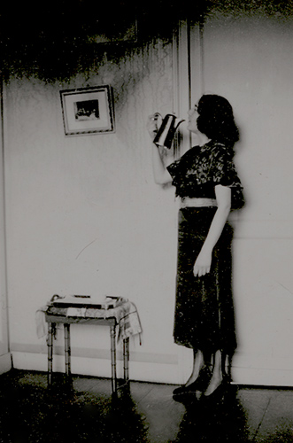Woman Drinking Directly from the Spout of a Coffee Pot