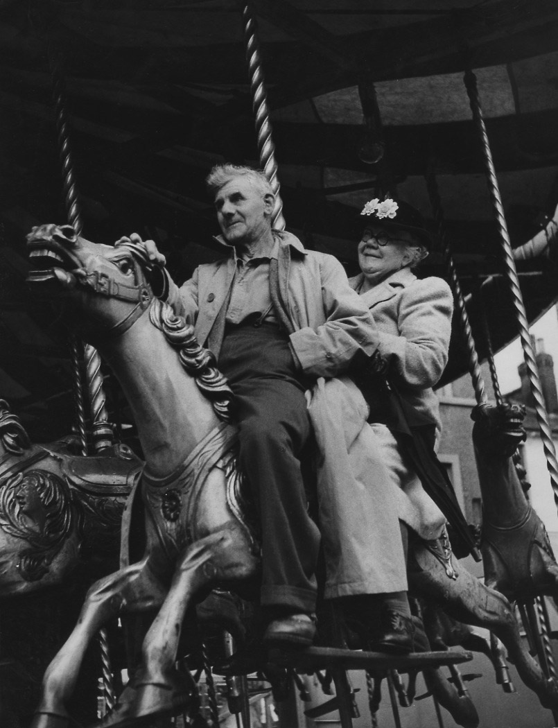 Izis (Israel Bidermanas) - A Couple on Carousel during August Bank Holiday Fair, London
